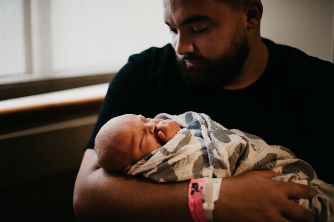 A father holding his newborn baby